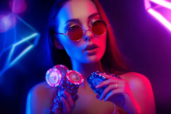 A glamorous woman holding casino chips in a neon-lit environment, representing the premium online casino atmosphere of JLPLUS.